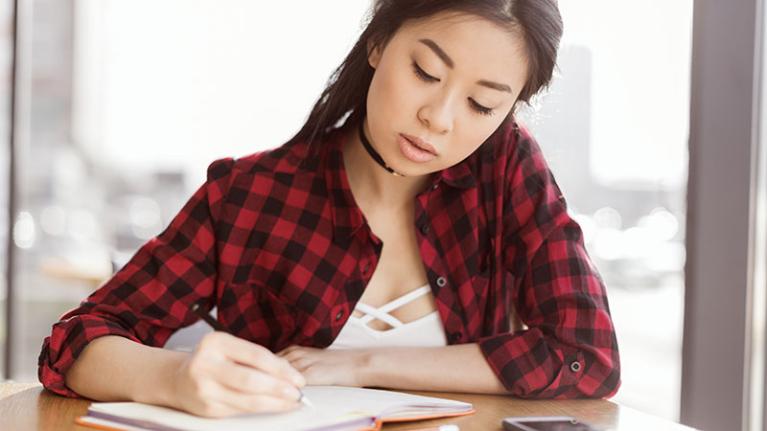 A young student works out a study schedule